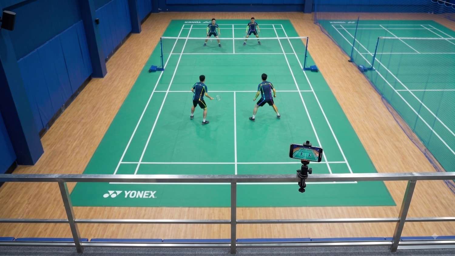 Badminton match being recorded from behind the court